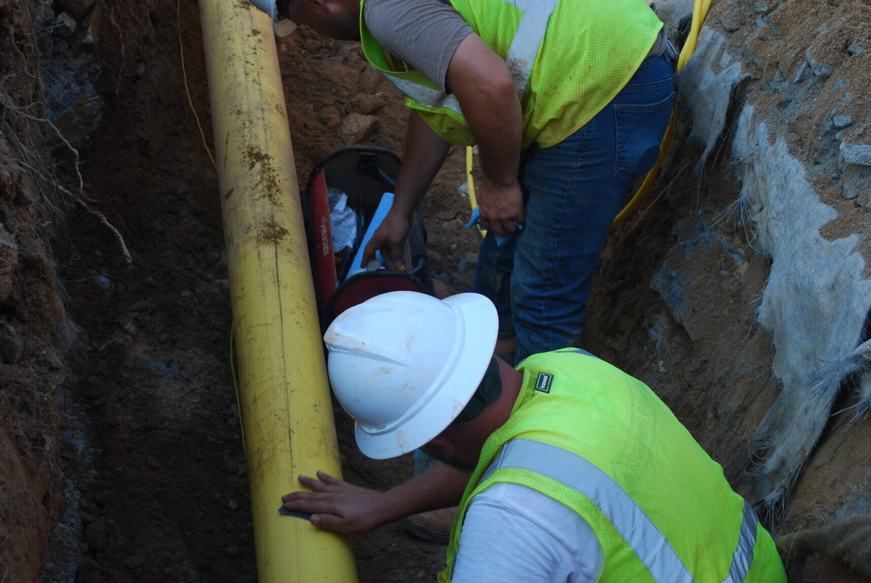 Southern Pipeline Employees inspecting the plastic pipeline