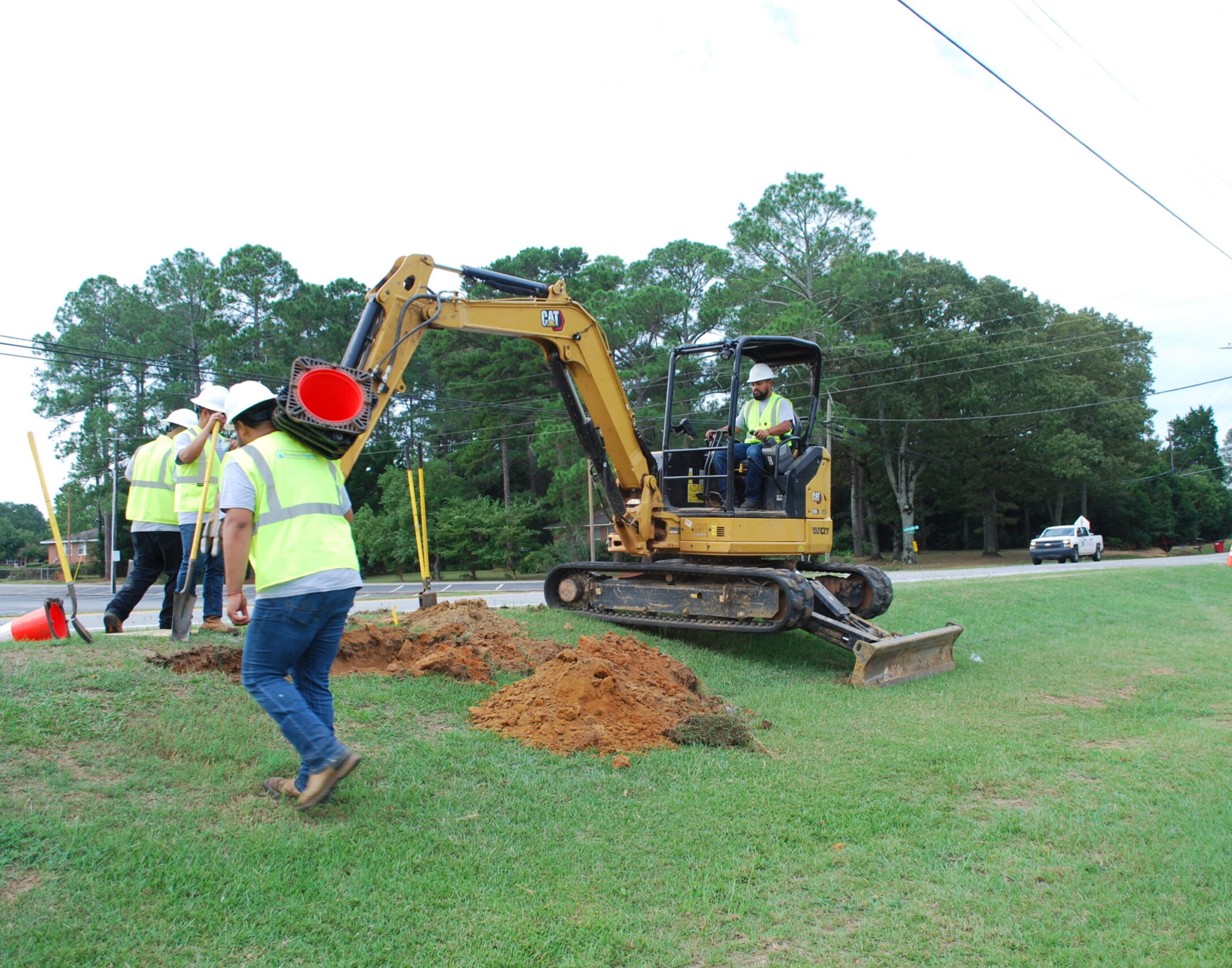 Southern Pipeline team setting up safety cones and running a tractor at job site