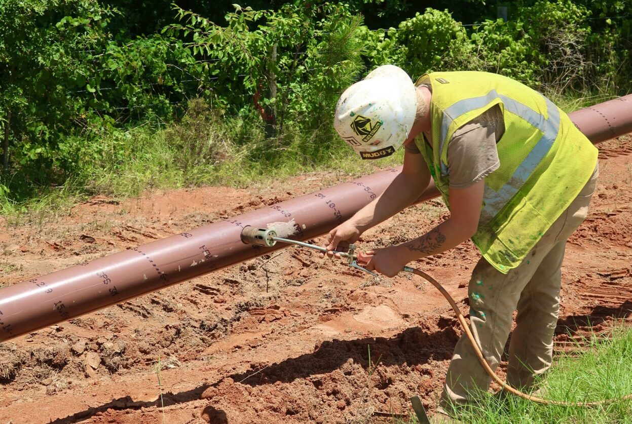 Southern Pipeline employee sealing any imperfections on Transmission Pipeline before coating the pipe